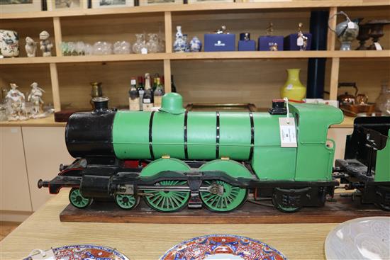 A 3.5 inch gauge 4-4-2 live steam locomotive and tender on wood stand, loco 27in. tender 18in.